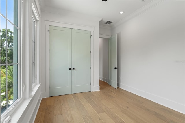 2200 N Glenwood Dr, Tampa, FL 33602 - unfurnished bedroom featuring crown molding, light wood-type flooring, baseboards, a closet, and recessed lighting