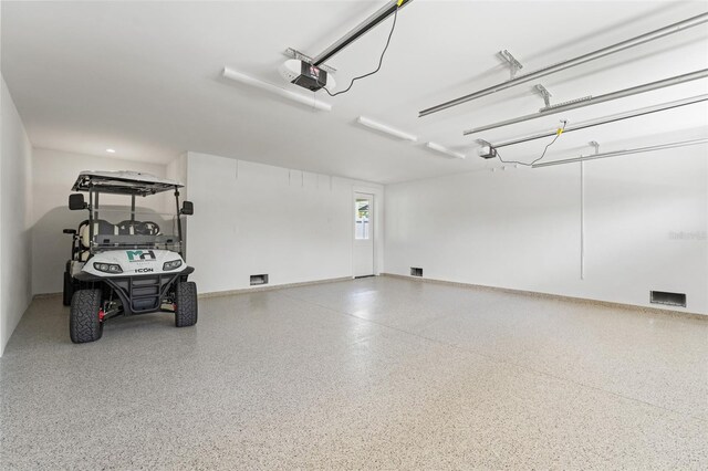 2200 N Glenwood Dr, Tampa, FL 33602 - garage featuring a garage door opener and baseboards
