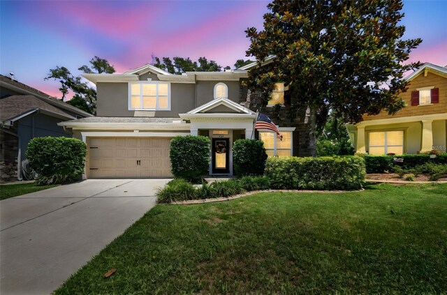 3530 Brook Crossing Dr, Brandon, FL 33511 - traditional-style house with driveway, a yard, stucco siding, and an attached garage