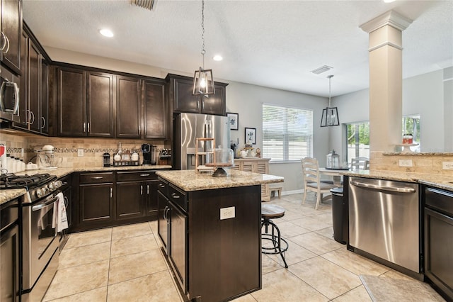 3530 Brook Crossing Dr, Brandon, FL 33511 - kitchen with stainless steel appliances, tasteful backsplash, a kitchen breakfast bar, light stone counters, and recessed lighting