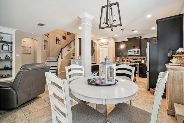 3530 Brook Crossing Dr, Brandon, FL 33511 - dining space featuring ornate columns, arched walkways, stairs, light tile patterned floors, and recessed lighting