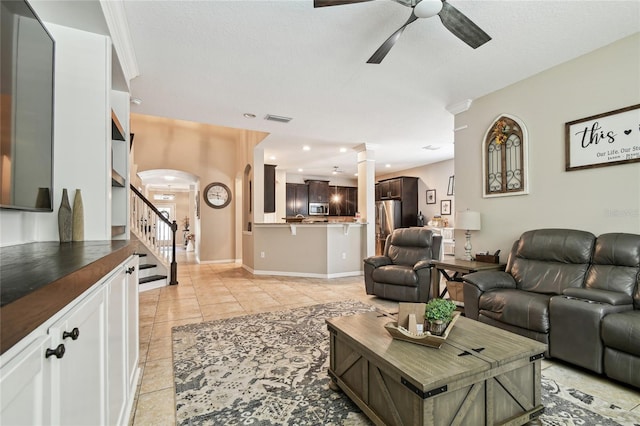 3530 Brook Crossing Dr, Brandon, FL 33511 - living room with a ceiling fan, stairway, ornate columns, light tile patterned floors, and baseboards