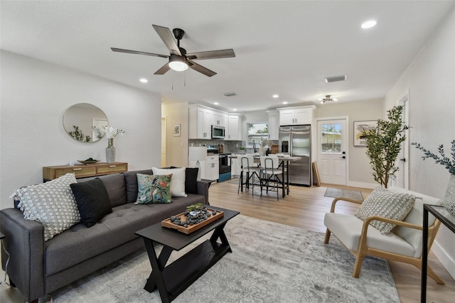 5624 62nd St N, Saint Petersburg, FL 33709 - living room featuring light wood-style flooring, a ceiling fan, and recessed lighting