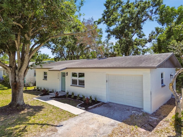 5624 62nd St N, Saint Petersburg, FL 33709 - single story home with dirt driveway, an attached garage, brick siding, and a shingled roof