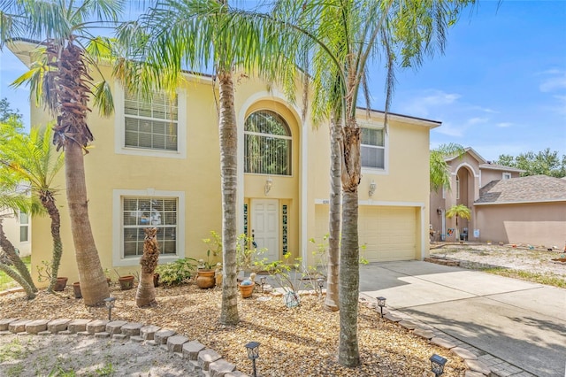 10311 Frog Pond Dr, Riverview, FL 33569 - view of front of home featuring stucco siding, a garage, and driveway