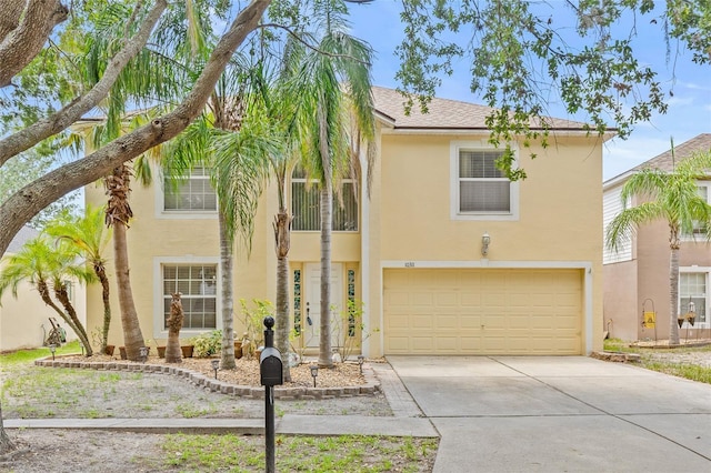 10311 Frog Pond Dr, Riverview, FL 33569 - view of front of property with a garage, driveway, stucco siding, and a shingled roof