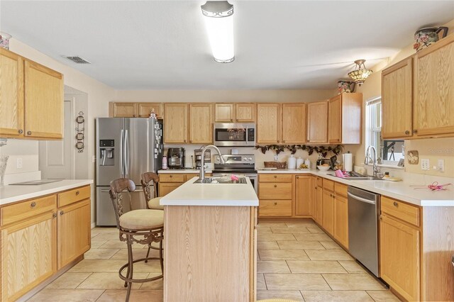 10311 Frog Pond Dr, Riverview, FL 33569 - kitchen with stainless steel appliances, light brown cabinets, and a sink