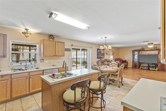 10311 Frog Pond Dr, Riverview, FL 33569 - kitchen featuring stainless steel dishwasher, open floor plan, light countertops, a center island, and a chandelier