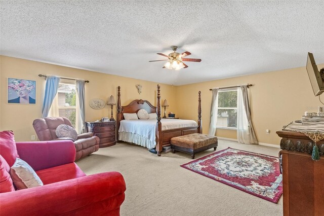 10311 Frog Pond Dr, Riverview, FL 33569 - carpeted bedroom featuring multiple windows, a textured ceiling, and a ceiling fan