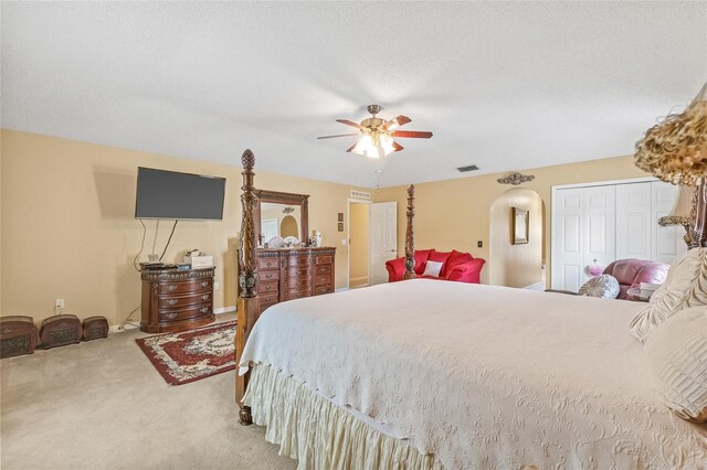 10311 Frog Pond Dr, Riverview, FL 33569 - carpeted bedroom with arched walkways, a ceiling fan, and a textured ceiling