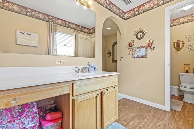 10311 Frog Pond Dr, Riverview, FL 33569 - bathroom featuring toilet, wood finished floors, vanity, and baseboards
