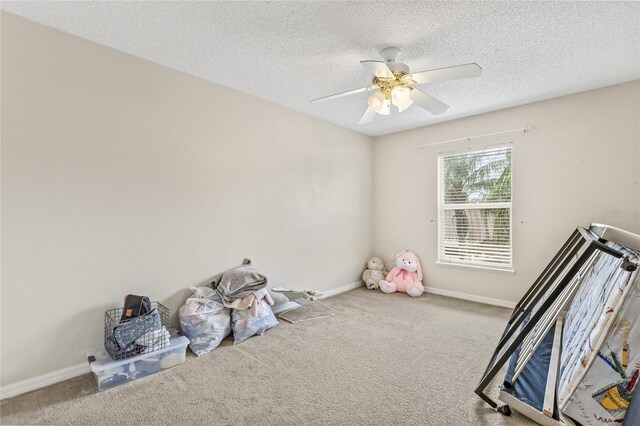 10311 Frog Pond Dr, Riverview, FL 33569 - unfurnished bedroom with carpet, a textured ceiling, ceiling fan, and baseboards