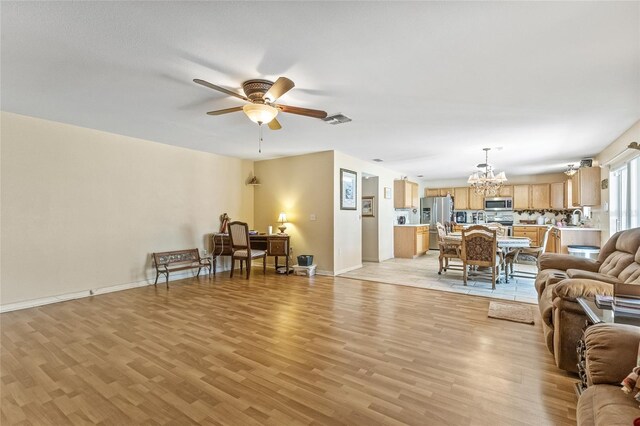 10311 Frog Pond Dr, Riverview, FL 33569 - living room with a chandelier, light wood finished floors, a ceiling fan, and baseboards