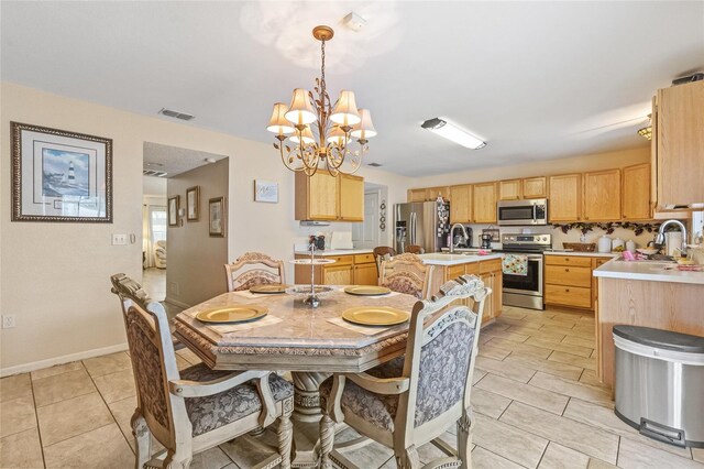 10311 Frog Pond Dr, Riverview, FL 33569 - dining room featuring a chandelier, light tile patterned floors, and baseboards