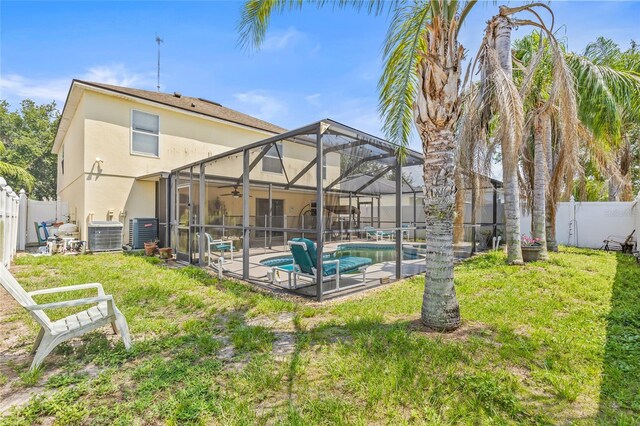 10311 Frog Pond Dr, Riverview, FL 33569 - rear view of house featuring stucco siding, ceiling fan, central AC, a patio area, and a lanai