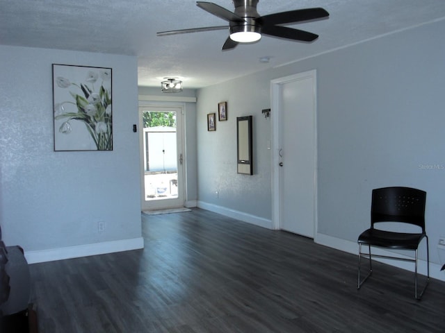 8996 Southern Comfort Dr, Largo, FL 33773 - unfurnished living room featuring dark wood-style flooring, baseboards, and a ceiling fan