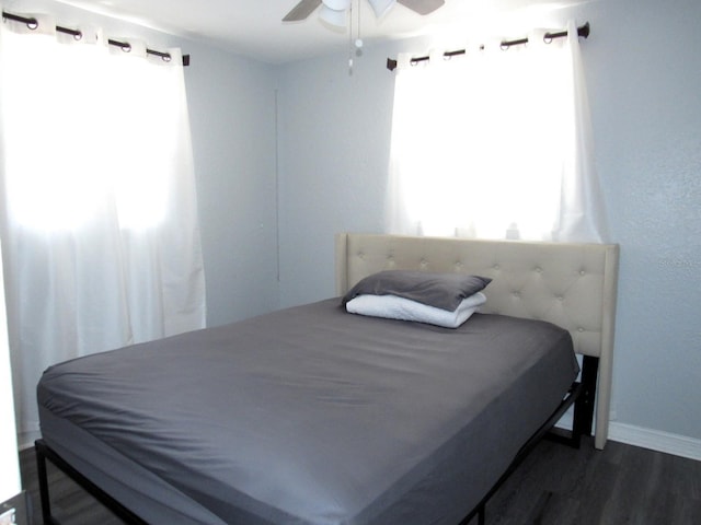 8996 Southern Comfort Dr, Largo, FL 33773 - bedroom with dark wood-style flooring, baseboards, and ceiling fan