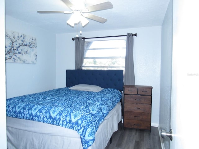 8996 Southern Comfort Dr, Largo, FL 33773 - bedroom featuring dark wood finished floors, a ceiling fan, and baseboards