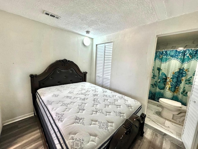 8996 Southern Comfort Dr, Largo, FL 33773 - bedroom featuring dark wood-style floors, a textured ceiling, and baseboards