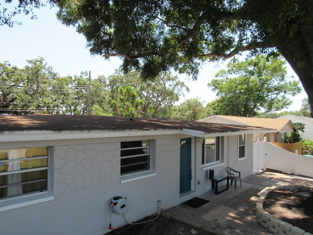 8996 Southern Comfort Dr, Largo, FL 33773 - rear view of house featuring a patio, fence, and roof with shingles