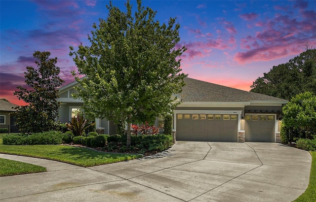 8016 Rock Spring Ct, Land O Lakes, FL 34638 - view of front of house featuring concrete driveway, an attached garage, a yard, and stone siding