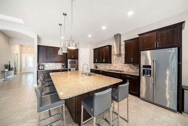 8016 Rock Spring Ct, Land O Lakes, FL 34638 - kitchen featuring stainless steel appliances, wall chimney range hood, backsplash, a breakfast bar area, and recessed lighting