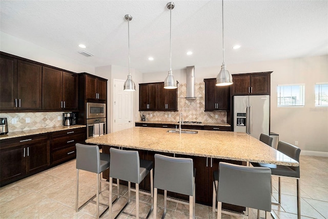 8016 Rock Spring Ct, Land O Lakes, FL 34638 - kitchen with appliances with stainless steel finishes, wall chimney range hood, a kitchen breakfast bar, tasteful backsplash, and recessed lighting
