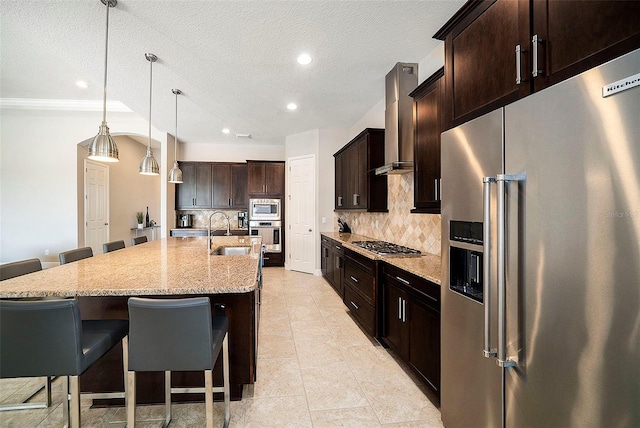 8016 Rock Spring Ct, Land O Lakes, FL 34638 - kitchen with appliances with stainless steel finishes, wall chimney exhaust hood, backsplash, a breakfast bar, and recessed lighting