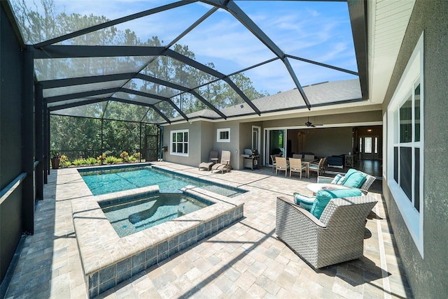 8016 Rock Spring Ct, Land O Lakes, FL 34638 - view of pool featuring a patio, outdoor lounge area, glass enclosure, and a pool with connected hot tub