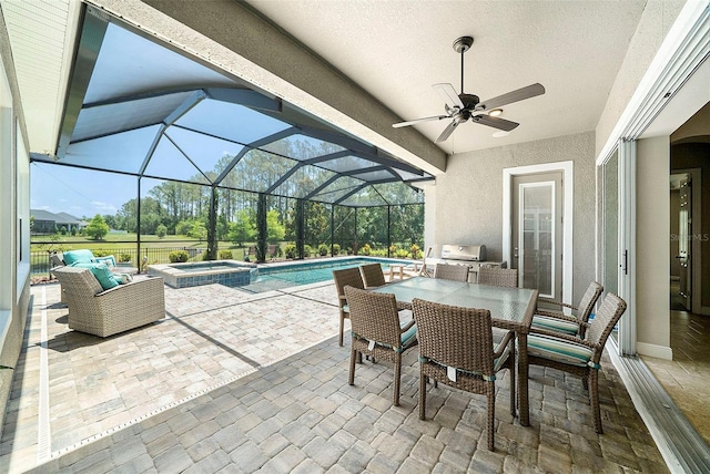 8016 Rock Spring Ct, Land O Lakes, FL 34638 - view of patio / terrace featuring exterior kitchen, outdoor dining area, a pool with connected hot tub, a ceiling fan, and a lanai