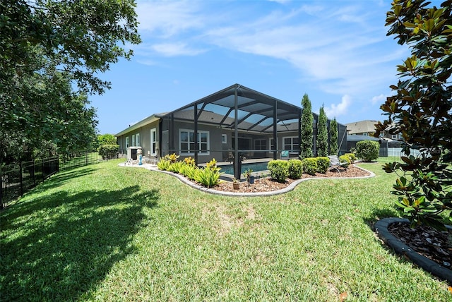 8016 Rock Spring Ct, Land O Lakes, FL 34638 - rear view of property with a fenced backyard, glass enclosure, and a patio area