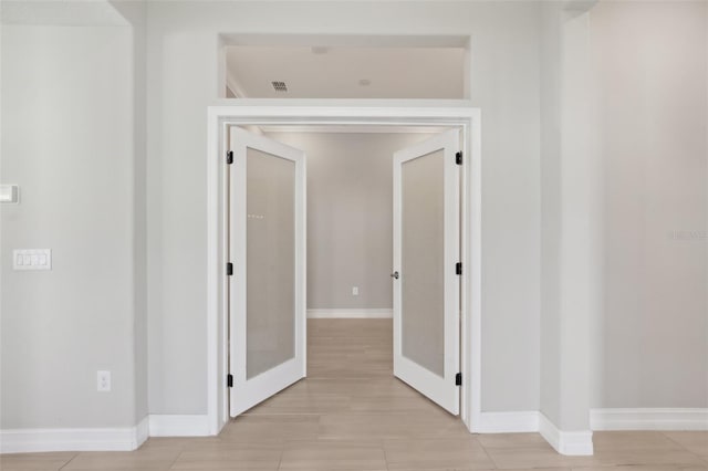4325 Barletta Ct, Wesley Chapel, FL 33543 - hallway featuring baseboards and french doors
