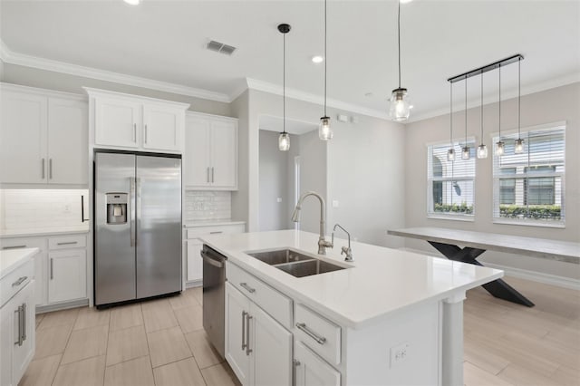 4325 Barletta Ct, Wesley Chapel, FL 33543 - kitchen featuring stainless steel appliances, a sink, tasteful backsplash, ornamental molding, and light countertops