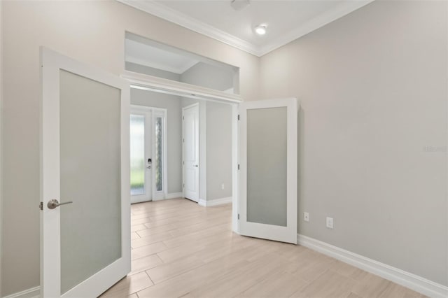 4325 Barletta Ct, Wesley Chapel, FL 33543 - unfurnished room featuring crown molding, french doors, baseboards, and light wood-style floors