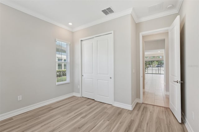 4325 Barletta Ct, Wesley Chapel, FL 33543 - unfurnished bedroom featuring light wood-style floors, multiple windows, ornamental molding, a closet, and baseboards