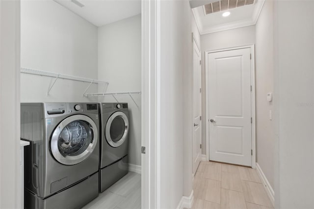 4325 Barletta Ct, Wesley Chapel, FL 33543 - laundry area with washing machine and dryer, ornamental molding, and baseboards