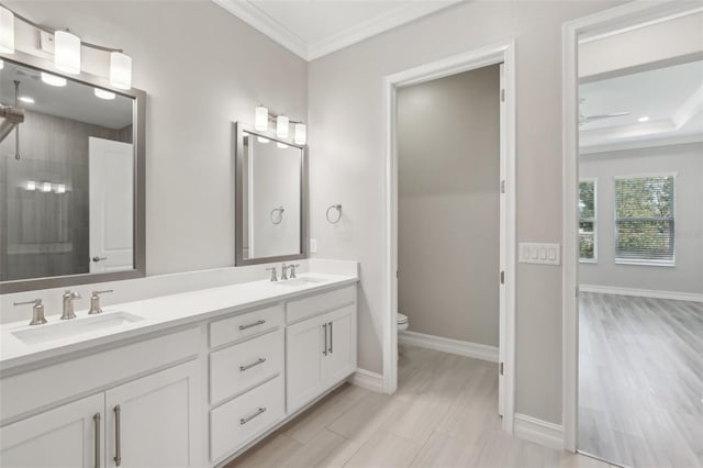 4325 Barletta Ct, Wesley Chapel, FL 33543 - bathroom featuring double vanity, crown molding, toilet, tiled shower, and baseboards