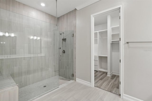 4325 Barletta Ct, Wesley Chapel, FL 33543 - bathroom featuring a stall shower, a walk in closet, baseboards, and recessed lighting