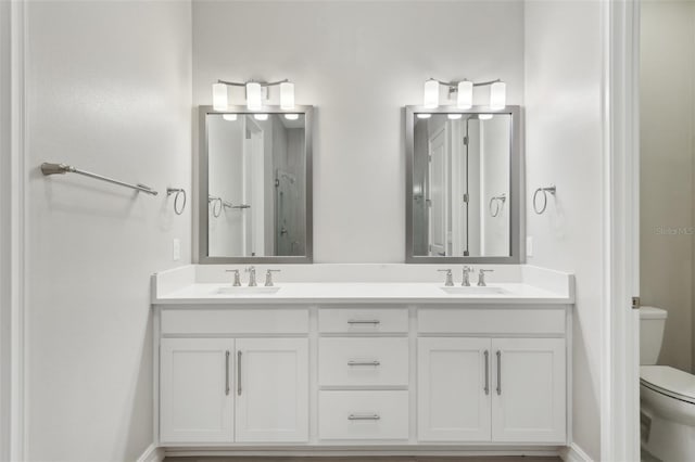 4325 Barletta Ct, Wesley Chapel, FL 33543 - bathroom featuring toilet, double vanity, and baseboards