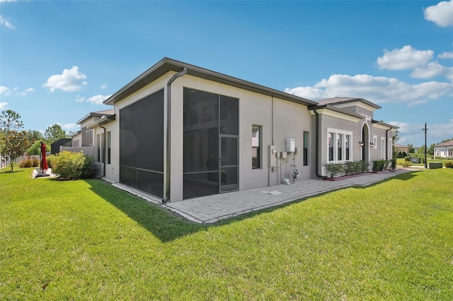 4325 Barletta Ct, Wesley Chapel, FL 33543 - rear view of property featuring stucco siding and a lawn