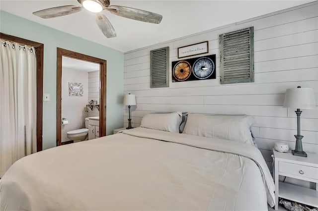 550 George St S, Tarpon Springs, FL 34688 - bedroom with wood walls, ensuite bathroom, and ceiling fan