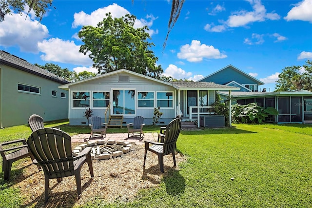 550 George St S, Tarpon Springs, FL 34688 - back of house featuring a sunroom, a lawn, entry steps, and an outdoor fire pit