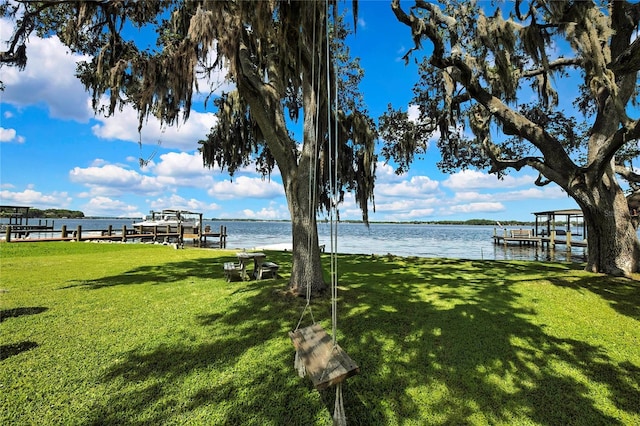 550 George St S, Tarpon Springs, FL 34688 - view of grassy yard featuring boat lift, a boat dock, and a water view