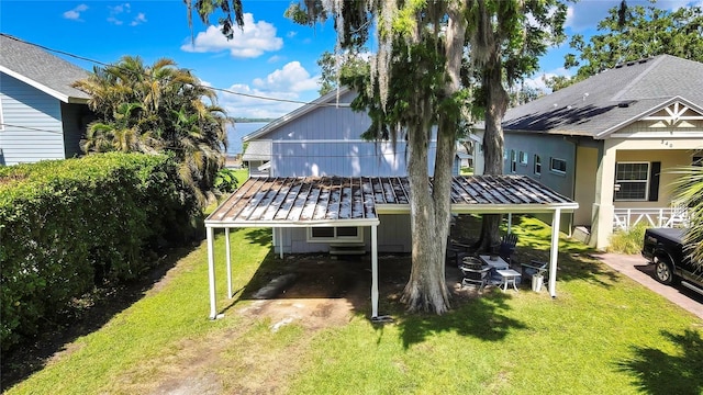 550 George St S, Tarpon Springs, FL 34688 - rear view of house with a yard and a carport