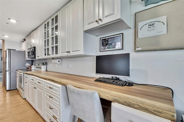 550 George St S, Tarpon Springs, FL 34688 - kitchen with stainless steel appliances, wooden counters, white cabinets, glass insert cabinets, and recessed lighting