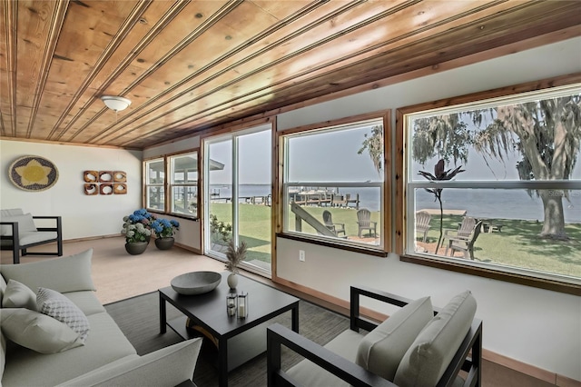 550 George St S, Tarpon Springs, FL 34688 - living room featuring wood ceiling, baseboards, and carpet floors