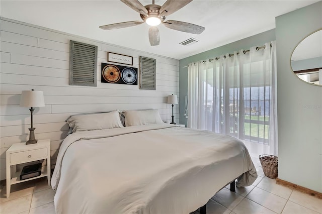 550 George St S, Tarpon Springs, FL 34688 - bedroom with light tile patterned floors, baseboards, ceiling fan, and wood walls