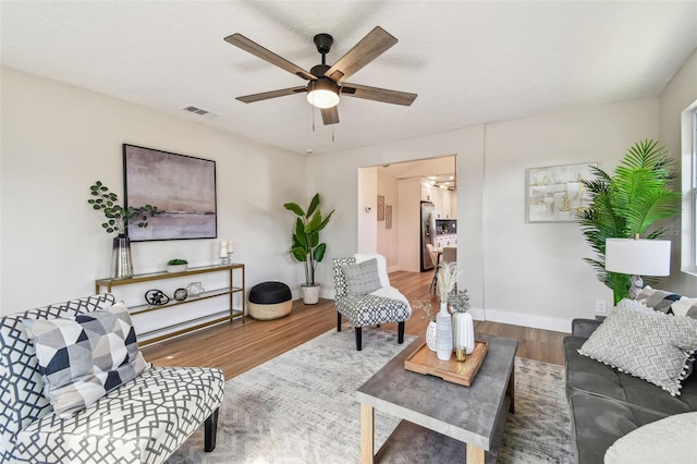 1750 Dayton St S, Saint Petersburg, FL 33712 - living area featuring wood finished floors, a ceiling fan, and baseboards