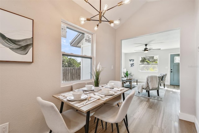 1750 Dayton St S, Saint Petersburg, FL 33712 - dining space featuring a chandelier, wood finished floors, lofted ceiling, and baseboards