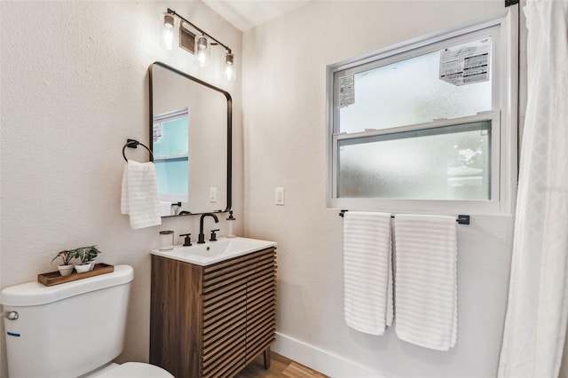 1750 Dayton St S, Saint Petersburg, FL 33712 - bathroom with toilet, vanity, and wood finished floors